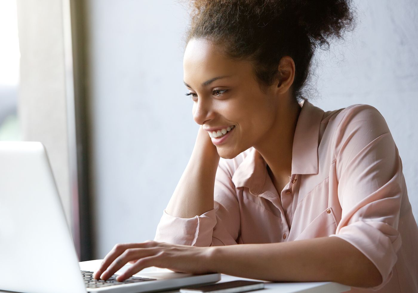 Smiling young woman with laptop